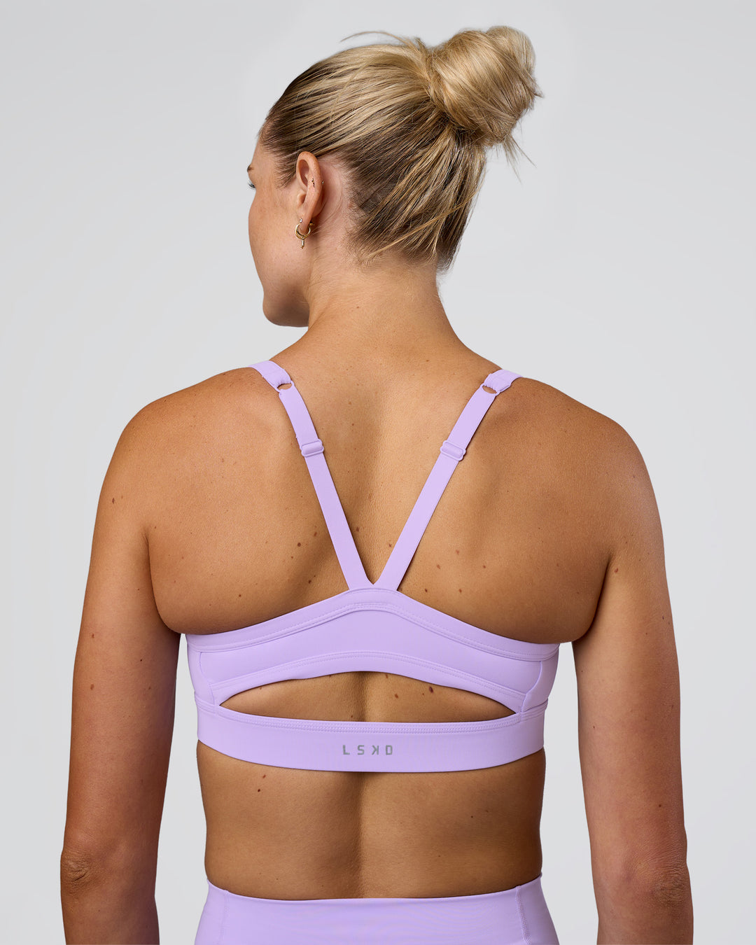 Woman wearing Momentum Sports Bra - Pale Lilac | Model:Emelia | Size:XS