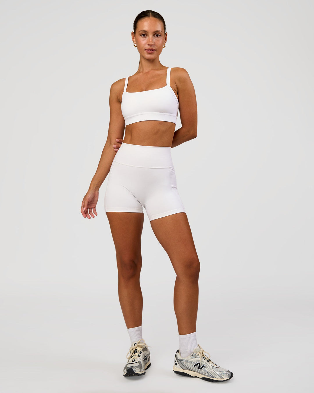Woman wearing Momentum Sports Bra - White | Model:Brylee | Size:XS