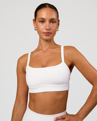 Woman wearing Momentum Sports Bra - White | Model:Brylee | Size:XS