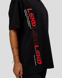 Woman wearing Nothing Is Impossible FLXCotton Oversized Tee - Black-Flame | Model:Bianca | Size:XS
