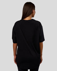 Woman wearing Nothing Is Impossible FLXCotton Oversized Tee - Black-Flame | Model:Bianca | Size:XS