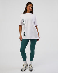 Woman wearing Nothing Is Impossible FLXCotton Oversized Tee - White-Vital Green | Model:Bianca | Size:XS