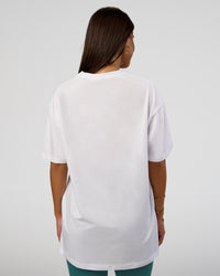Woman wearing Nothing Is Impossible FLXCotton Oversized Tee - White-Vital Green | Model:Bianca | Size:XS
