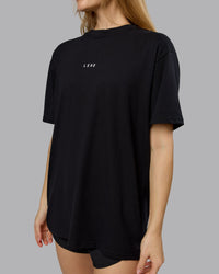 Woman wearing On Repeat FLXCotton Oversized Tee - Black-White | Model:Emilie | Size:XS