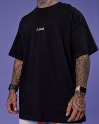 Man wearing Our Journey Heavyweight Oversized Tee - Black-Rainbow | Model:Tayden | Size:XS