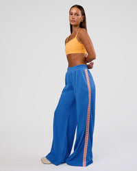Woman wearing Peaches Track Pant - Palace Blue | Model:Brylee | Size:XS | Thumbnail Index: 6