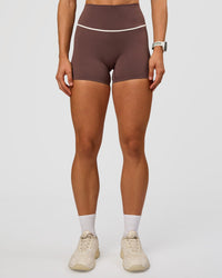 Woman wearing Pinnacle High-Rise 4" Short - Cocoa Powder-Off White | Model:Maja | Size:XS