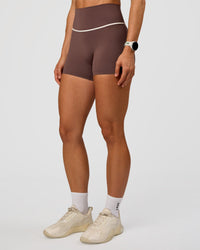 Woman wearing Pinnacle High-Rise 4" Short - Cocoa Powder-Off White | Model:Maja | Size:XS
