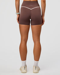 Woman wearing Pinnacle High-Rise 4" Short - Cocoa Powder-Off White | Model:Maja | Size:XS