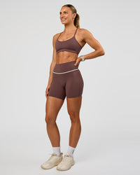 Woman wearing Pinnacle High-Rise 6" Short - Cocoa Powder-Off White | Model:Maja | Size:XS
