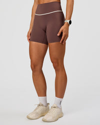 Woman wearing Pinnacle High-Rise 6" Short - Cocoa Powder-Off White | Model:Maja | Size:XS