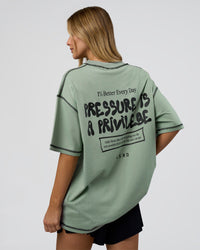 Woman wearing Pressure is Privilege Oversized Tee - Iceberg Green-Black | Model:Leilani | Size:XS