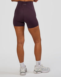 Woman wearing Progression Ultra High-Rise 4" Short - Midnight Plum | Model:Brylee | Size:XS