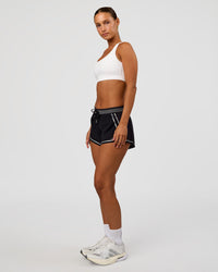 Woman wearing Race Day Sports Bra - White | Model:Brylee | Size:XS
