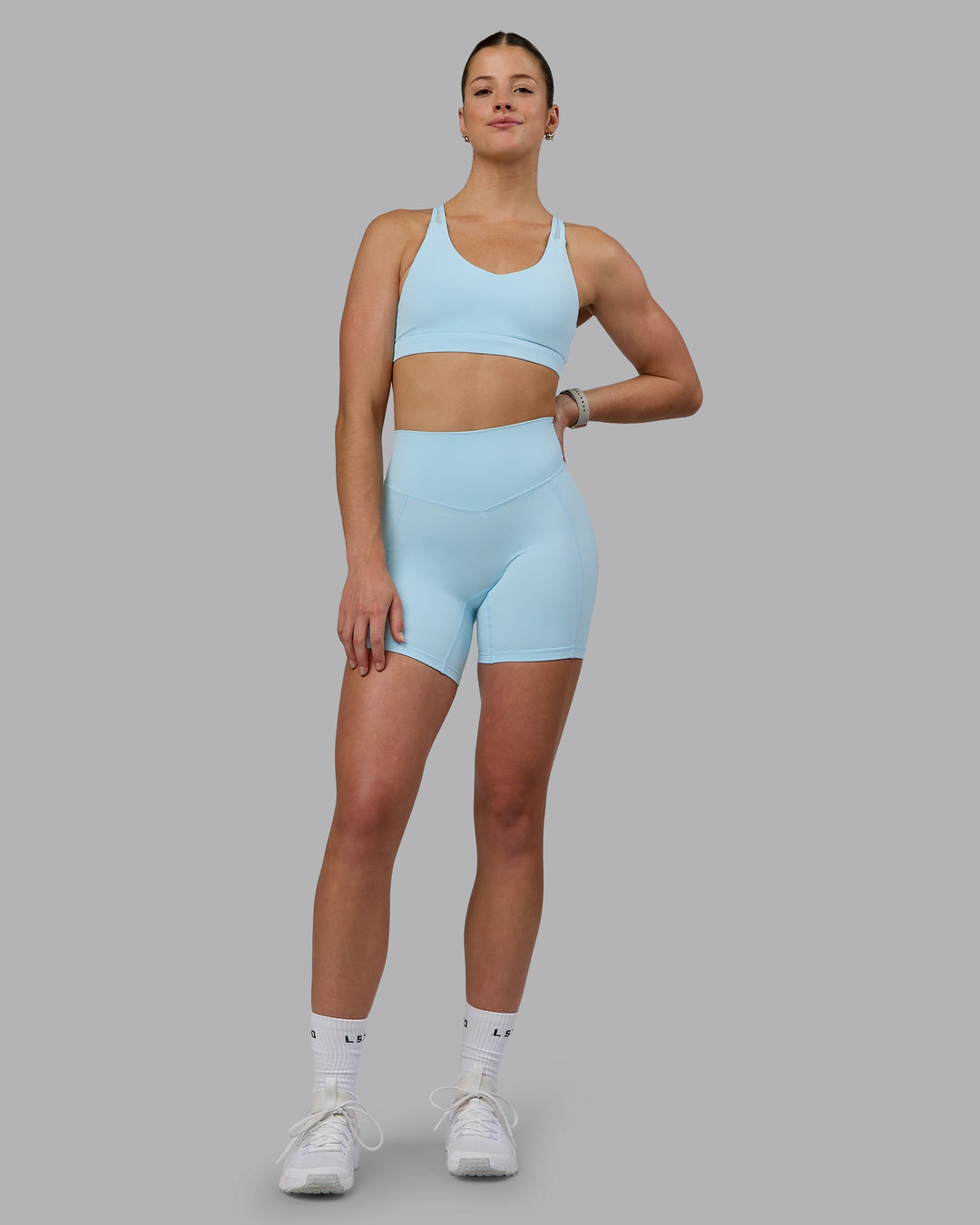 Woman wearing Radiance Sports Bra - Crystal Blue