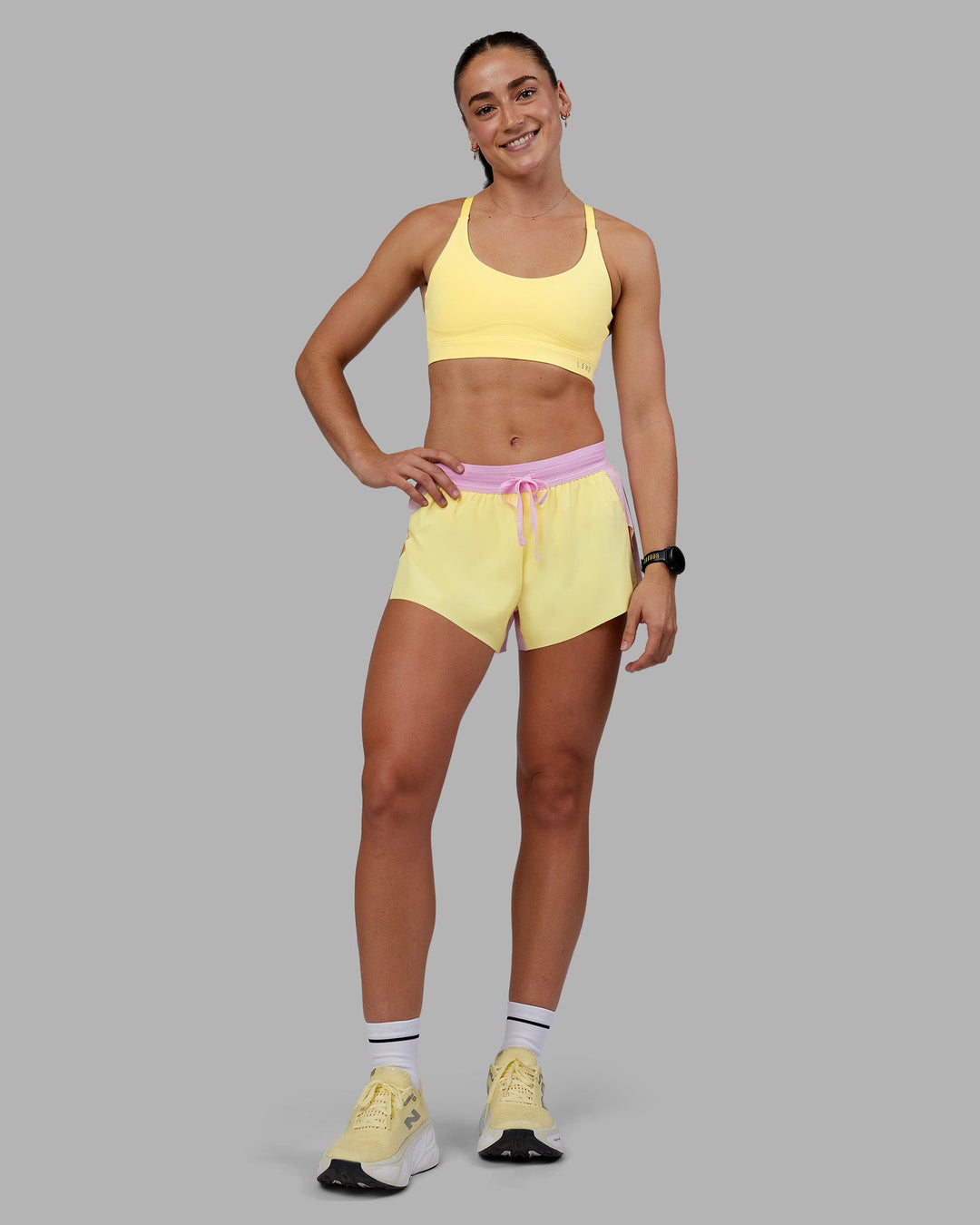 Woman wearing Rapid Sports Bra - Lemon | Model:Grace | Size:XS