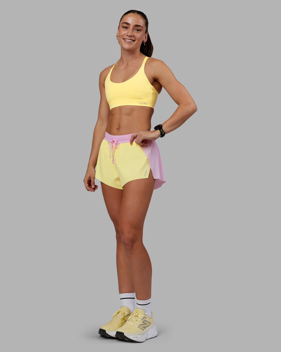 Woman wearing Rapid Sports Bra - Lemon | Model:Grace | Size:XS