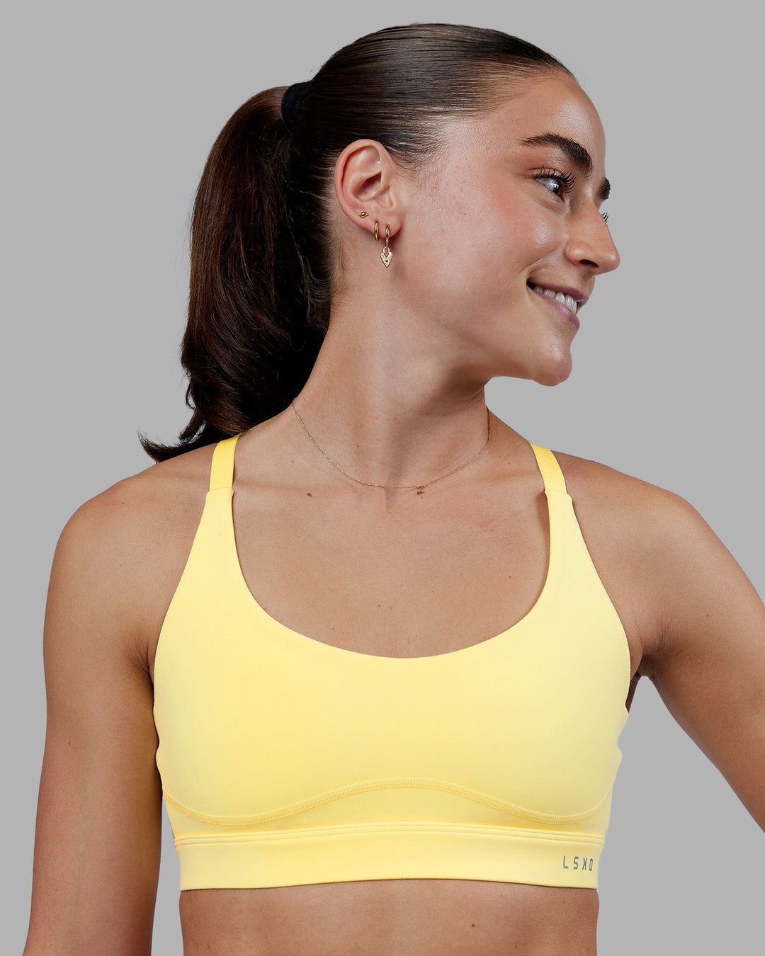 Woman wearing Rapid Sports Bra - Lemon | Model:Grace | Size:XS