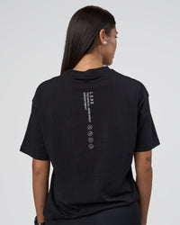 Woman wearing Research Department FLXCotton Oversized Tee - Black | Model:Rhiley | Size:XS
