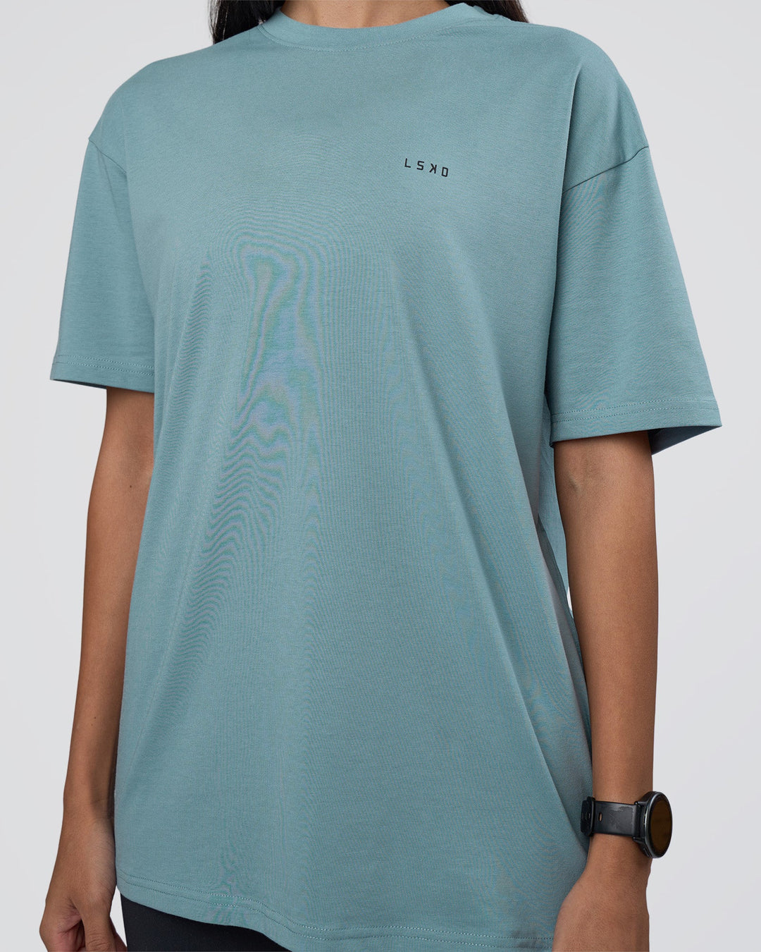 Woman wearing Research Department FLXCotton Oversized Tee - Smoke Blue | Model:Rhiley | Size:XS