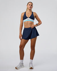 Woman wearing Revitalise Flash Sports Bra - Future Navy-Multi | Model:Emelia | Size:XS