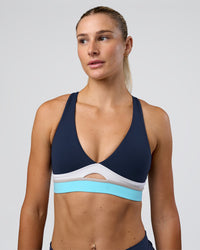 Woman wearing Revitalise Flash Sports Bra - Future Navy-Multi | Model:Emelia | Size:XS