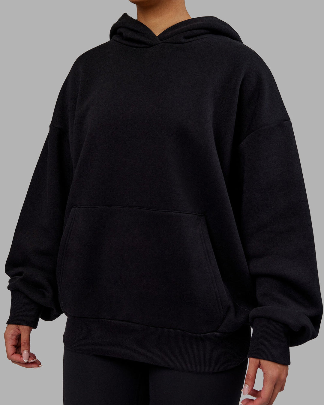 Woman wearing Rise &amp; Lift Hoodie Oversized - Black-White | Model:Ayla | Size:XS