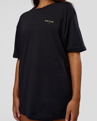 Woman wearing RUN CLUB FLXCotton Tee Oversize - Black-Yellow Fizz | Model:Kirstyn | Size:XS