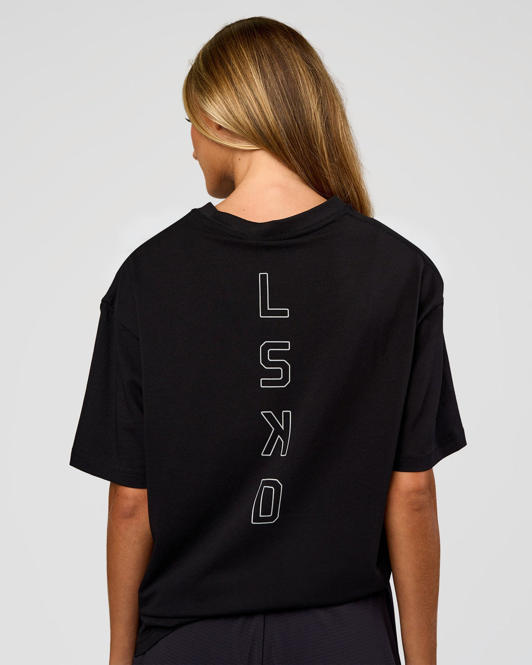 Woman wearing Run Club Script FLXCotton Oversized Tee - Black-Alloy | Model:Georgia | Size:XS