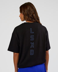 Woman wearing Run Club Script FLXCotton Oversized Tee - Black-Palace Blue | Model:Dakota | Size:XS