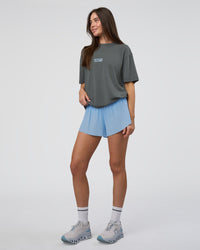 Woman wearing Runner's FLXCotton Oversized Tee - Dark Storm Washed-Open Air | Model:Estella | Size:XS