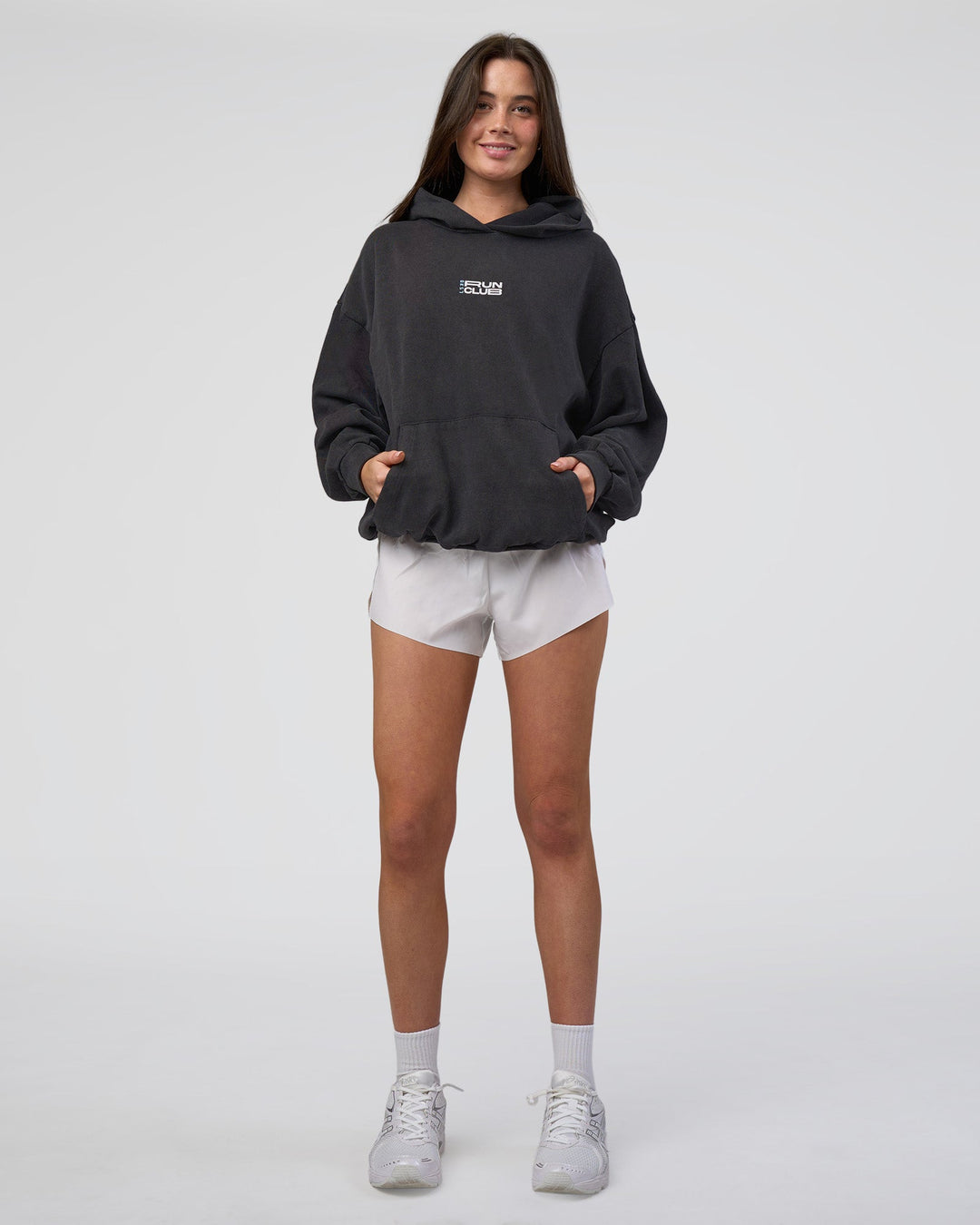 Woman wearing Runner’s Unisex Oversized Hoodie - Black Washed-White | Model:Estella | Size:XS