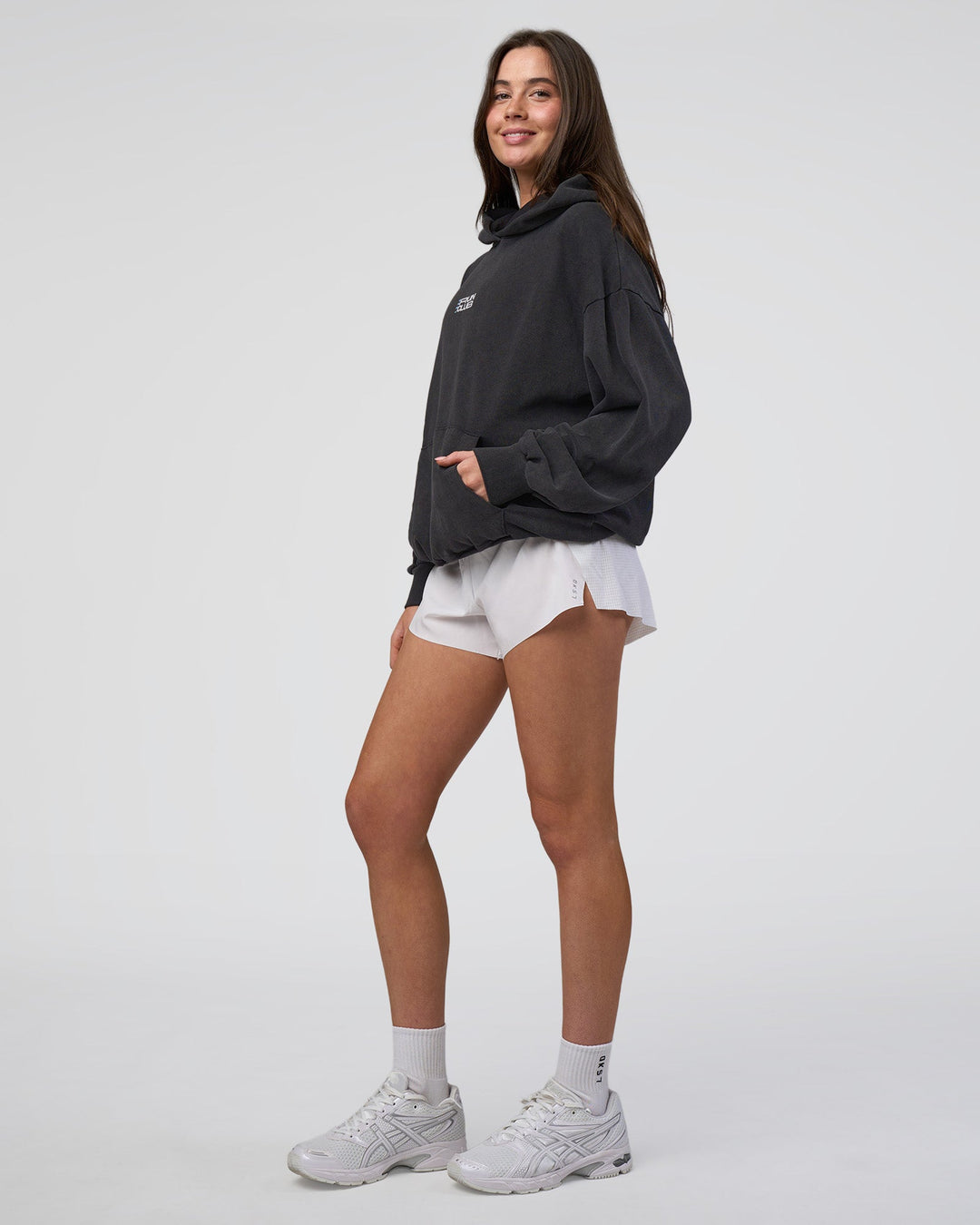 Woman wearing Runner’s Unisex Oversized Hoodie - Black Washed-White | Model:Estella | Size:XS
