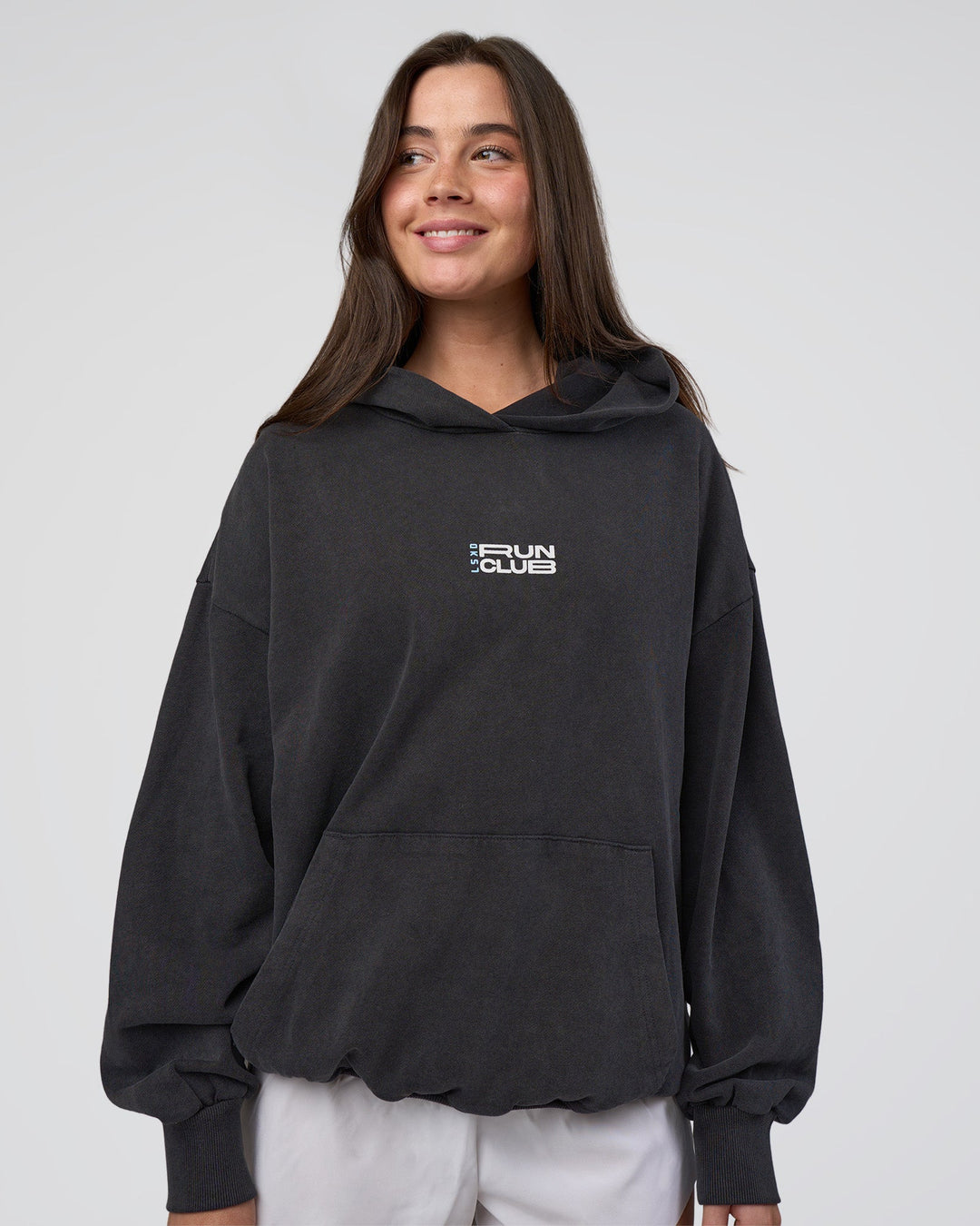 Woman wearing Runner’s Unisex Oversized Hoodie - Black Washed-White | Model:Estella | Size:XS