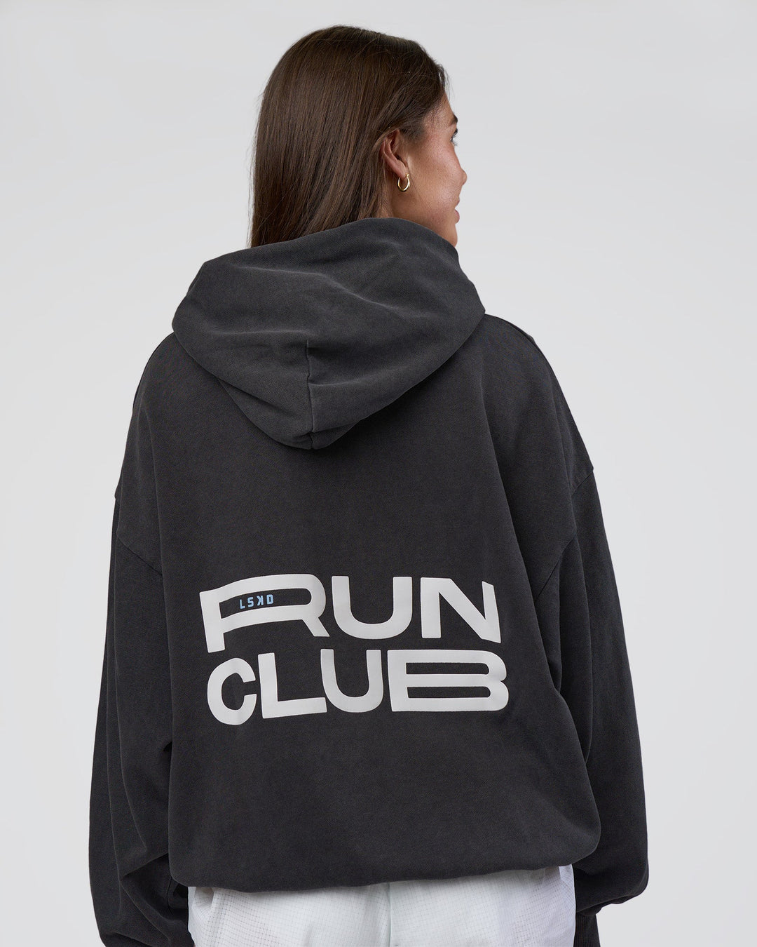 Woman wearing Runner’s Unisex Oversized Hoodie - Black Washed-White | Model:Estella | Size:XS