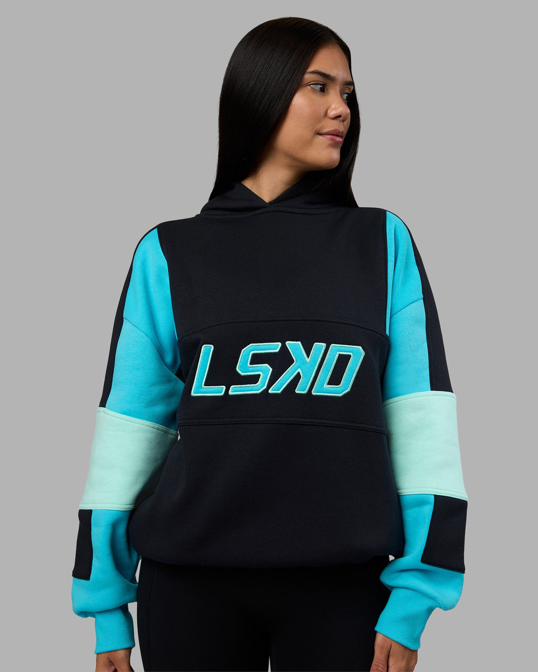 Woman wearing Slam Oversized Hoodie - Caviar-Blue Atoll | Model:Rhiley | Size:XS