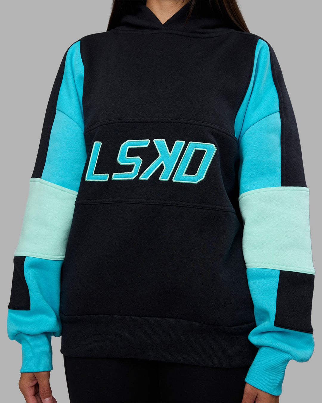 Woman wearing Slam Oversized Hoodie - Caviar-Blue Atoll | Model:Rhiley | Size:XS