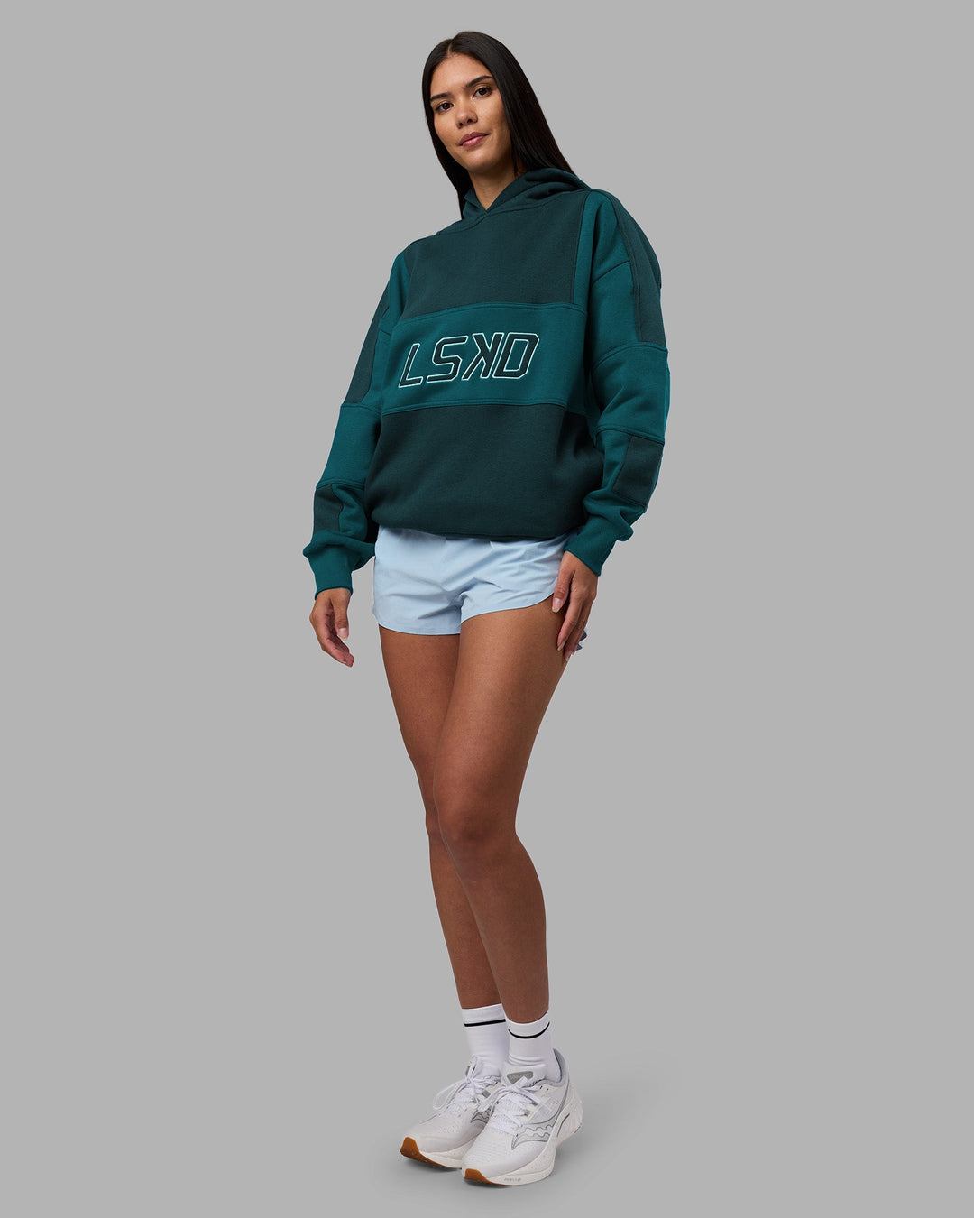 Woman wearing Slam Oversized Hoodie - Deep Sea-Blue Coral | Model:Rhiley | Size:XS