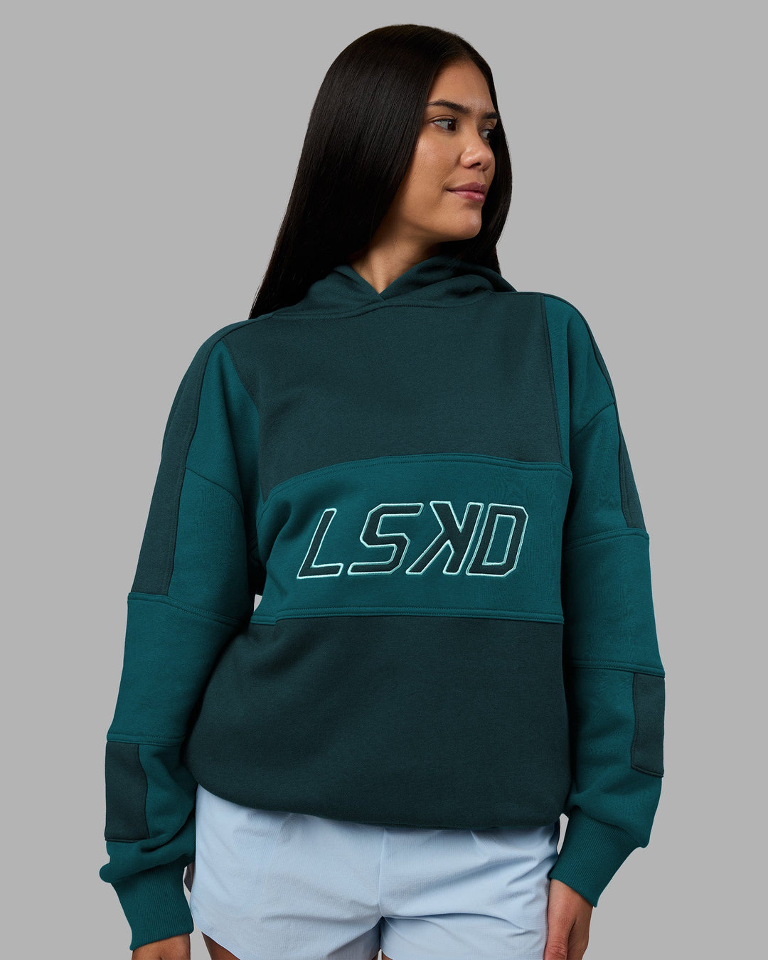 Woman wearing Slam Oversized Hoodie - Deep Sea-Blue Coral | Model:Rhiley | Size:XS