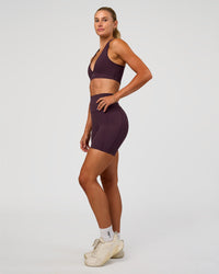 Woman wearing Stamina Sports Bra - Midnight Plum | Model:Emelia | Size:XS