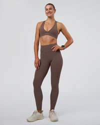 Woman wearing Stamina Sports Bra - Peppercorn | Model:Emelia | Size:XS