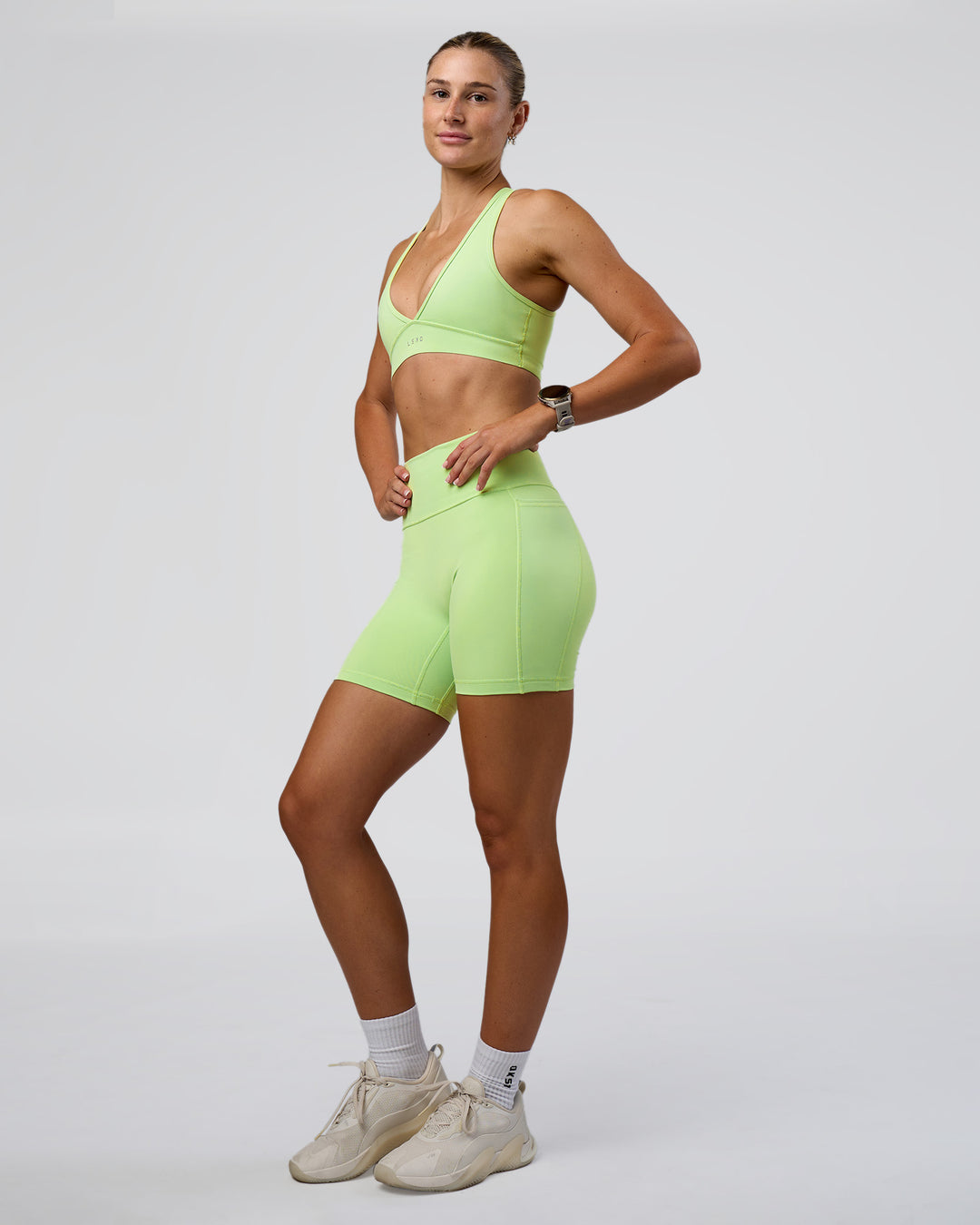 Woman wearing Stamina Sports Bra - Solar Lime | Model:Emelia | Size:XS