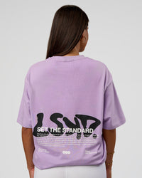 Woman wearing Standard Issue FLXCotton Oversized Tee - Pale Lilac-Black | Model:Bianca | Size:XS