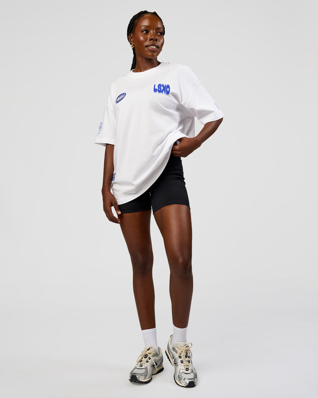 Woman wearing Static Grit Heavyweight Oversized Tee - White-Electric Indigo | Model:Ellie | Size:XS