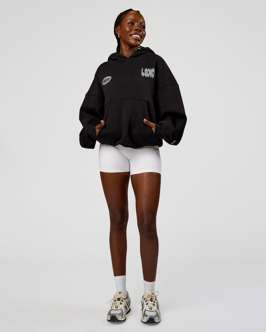 Woman wearing Static Grit Unisex Boxy Hoodie - Black-Alloy | Model:Ellie | Size:XS