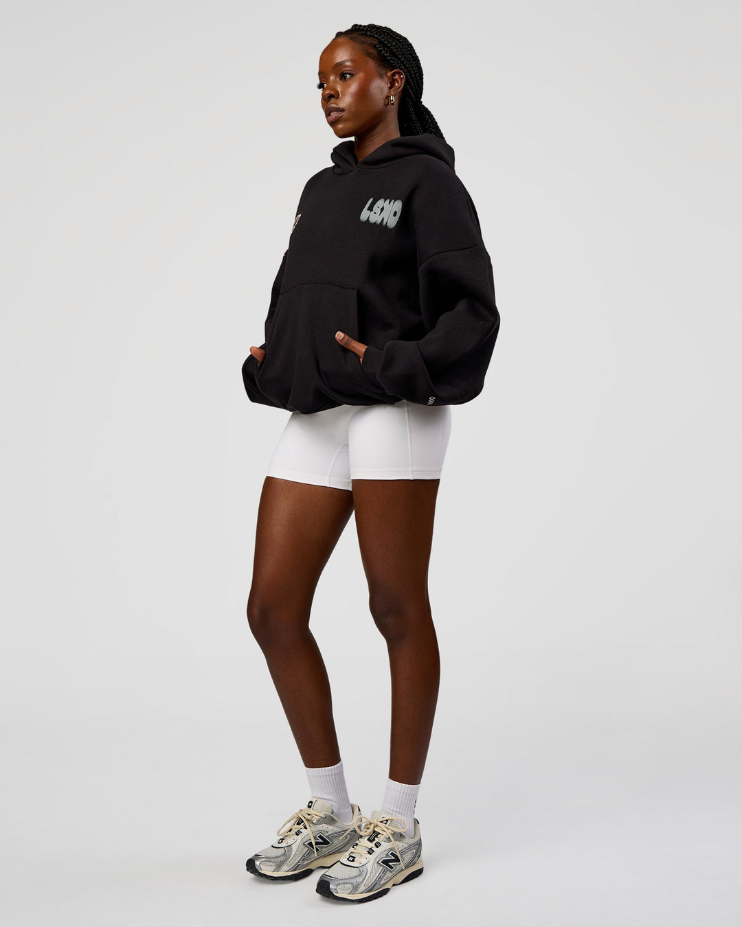 Woman wearing Static Grit Unisex Boxy Hoodie - Black-Alloy | Model:Ellie | Size:XS