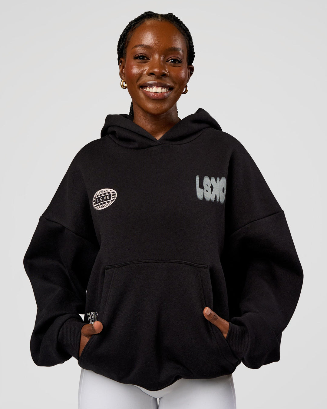 Woman wearing Static Grit Unisex Boxy Hoodie - Black-Alloy | Model:Ellie | Size:XS