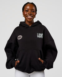 Woman wearing Static Grit Unisex Boxy Hoodie - Black-Alloy | Model:Ellie | Size:XS
