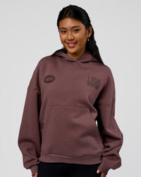Woman wearing Static Grit Unisex Boxy Hoodie - Cocoa Powder-Hot Chocolate | Model:Loren | Size:XS