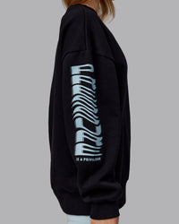 Woman wearing Static Oversized Sweater - Black-Skyride | Model:Emilie | Size:XS